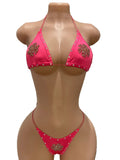 Front view of pink rhinestone snowflake bikini set on mannequin