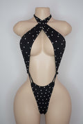 Black rhinestone cutout bodysuit with crossover halter neck on mannequin