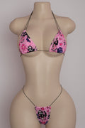 Pink horror graphic rhinestone bikini set with triangle top and thong bottom on mannequin