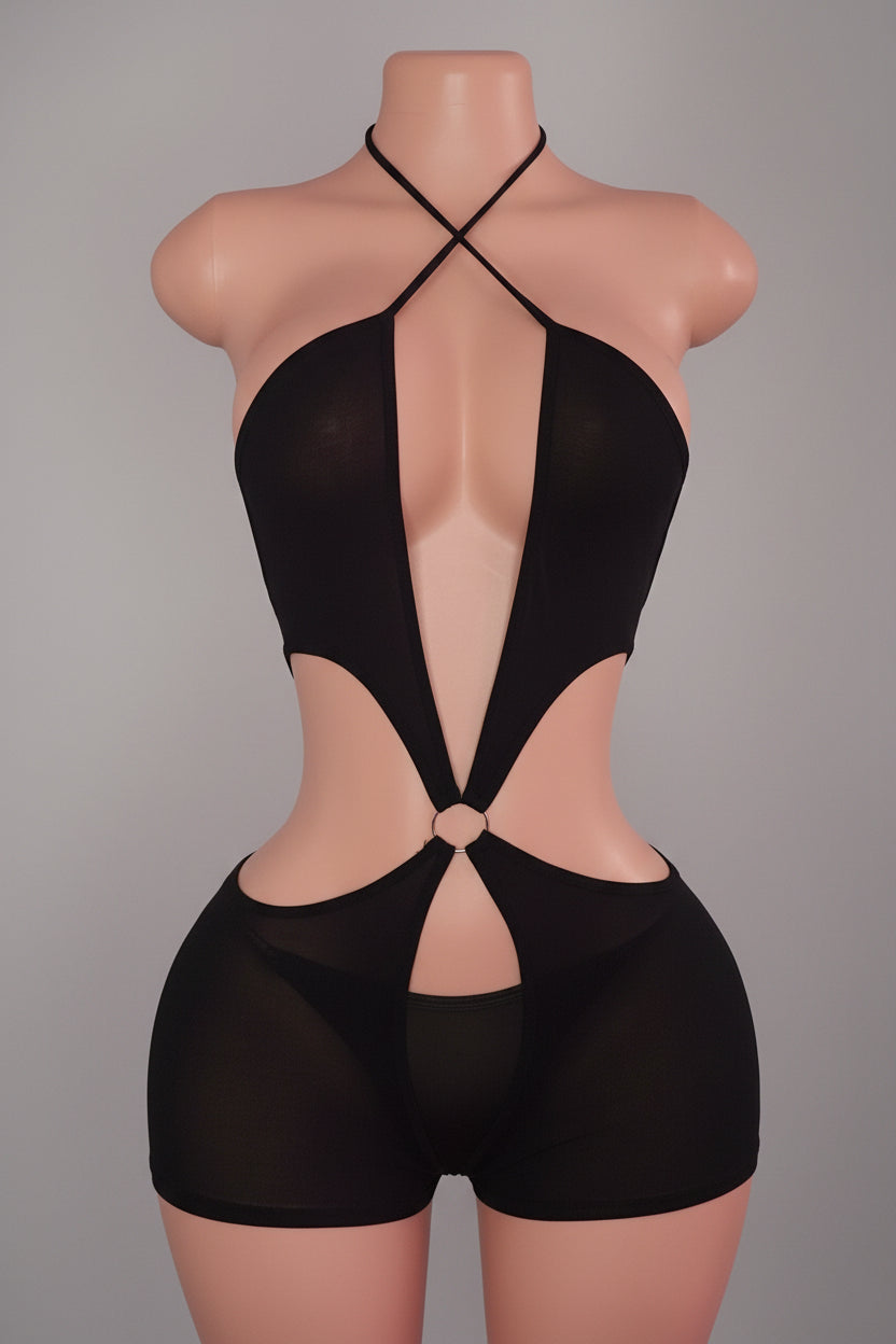 Black cutout romper with criss-cross halter neck and O-ring hardware on mannequin