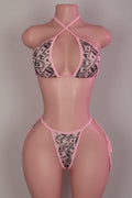 Money print bikini set with criss-cross halter top and string tie bottoms on mannequin